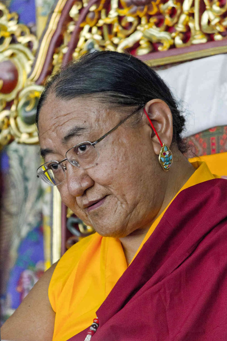 His Holiness the 41st Sakya Trizin in elaborate ceremonial crown and brocade robes, performing a sacred ritual that he has transmitted to the next generation of the Khön lineage