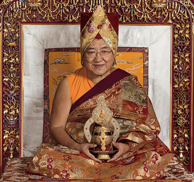 His Holiness the 41st Sakya Trizin Ngawang Kunga in formal ceremonial attire holding a sacred vajra, seated upon the golden Sakya throne